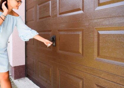 A technician from Bulldog Garage Door Repair conducting preventive maintenance on a garage door.
