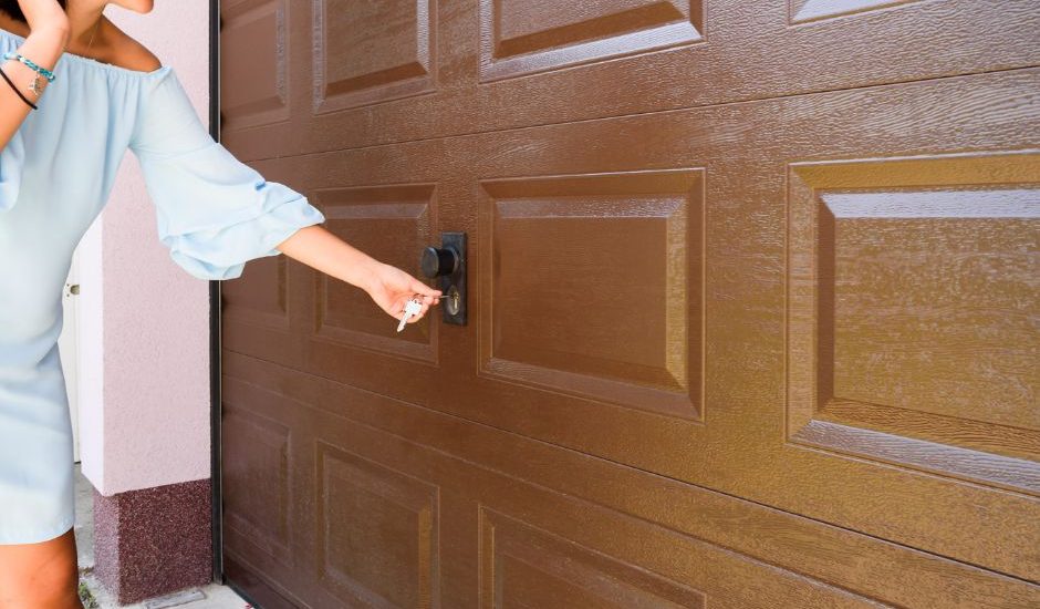 A technician from Bulldog Garage Door Repair conducting preventive maintenance on a garage door.