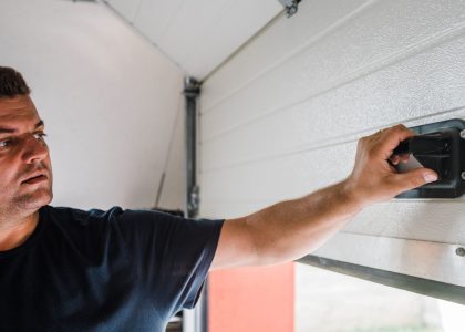 A technician from Bulldog Garage Door Repair conducting preventive maintenance on a garage door.