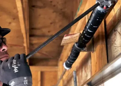 man fixing garage door spring