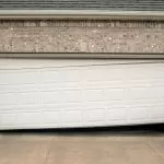 Close-up of a damaged garage door mechanism.