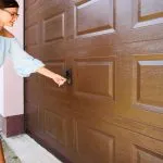 A technician from Bulldog Garage Door Repair conducting preventive maintenance on a garage door.