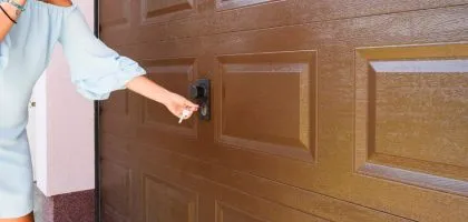 A technician from Bulldog Garage Door Repair conducting preventive maintenance on a garage door.