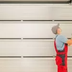 A technician from Bulldog Garage Door Repair conducting preventive maintenance on a garage door.