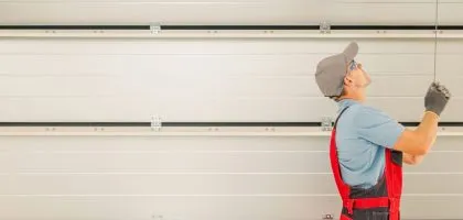 A technician from Bulldog Garage Door Repair conducting preventive maintenance on a garage door.