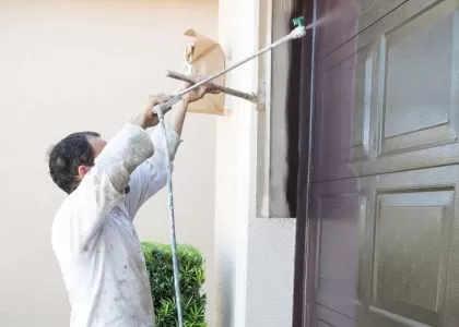 Professional technician examining a garage door mechanism.