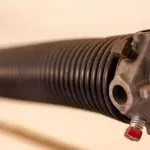 Close-up view of a garage door spring system.
