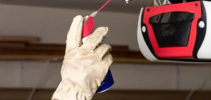 A technician from Bulldog Garage Door Repair conducting preventive maintenance on a garage door.